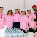 6 volunteers in pink tshirts in a pose