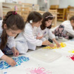 Young Students Seen Painting