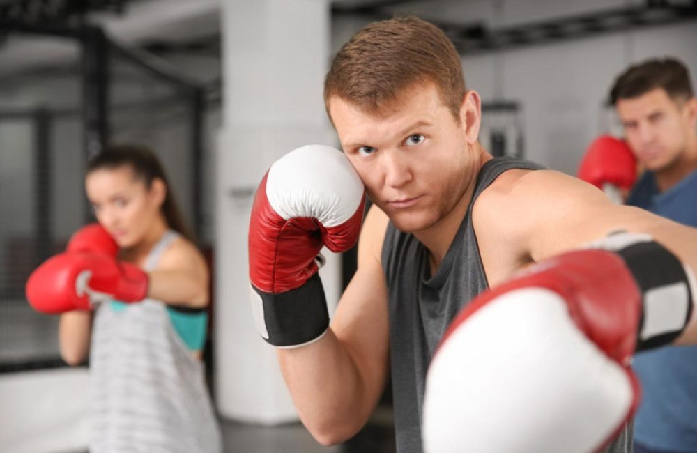 A group of people training at a boxing class.